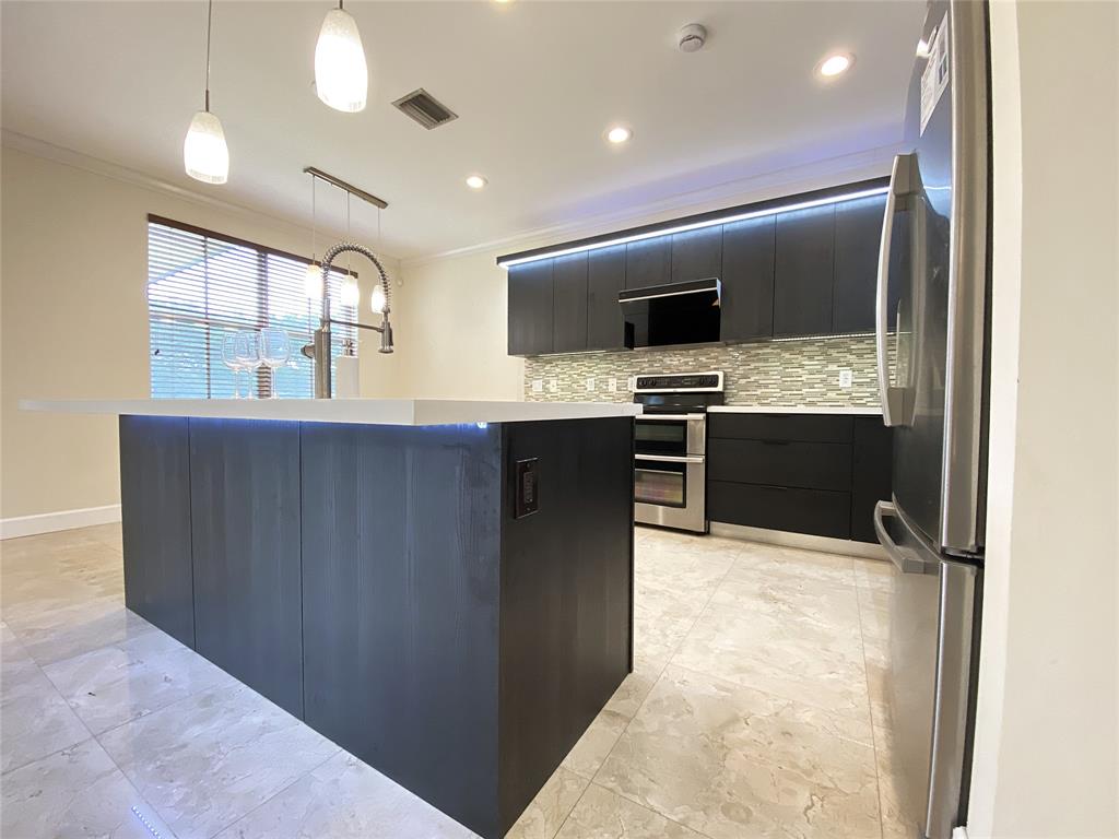 4375 Foxtail Lane Weston, FL 33331 - Photo 11 of 84 a kitchen with stainless steel appliances granite countertop a stove and a sink
