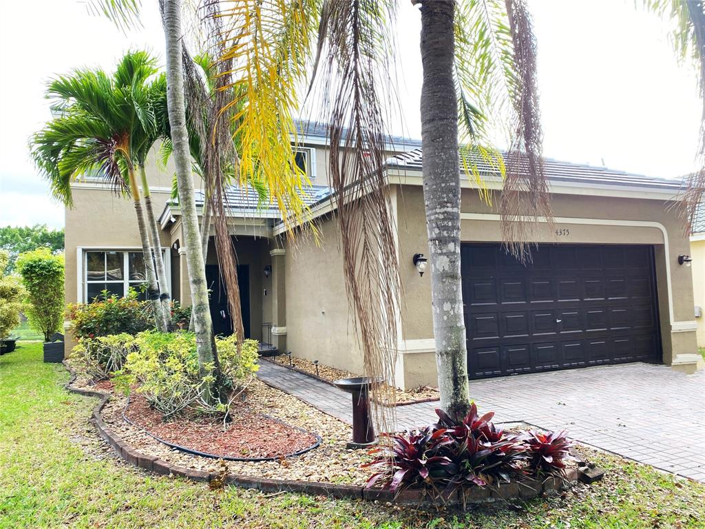 4375 Foxtail Lane Weston, FL 33331 - Photo 3 of 84 a front view of a house with a yard