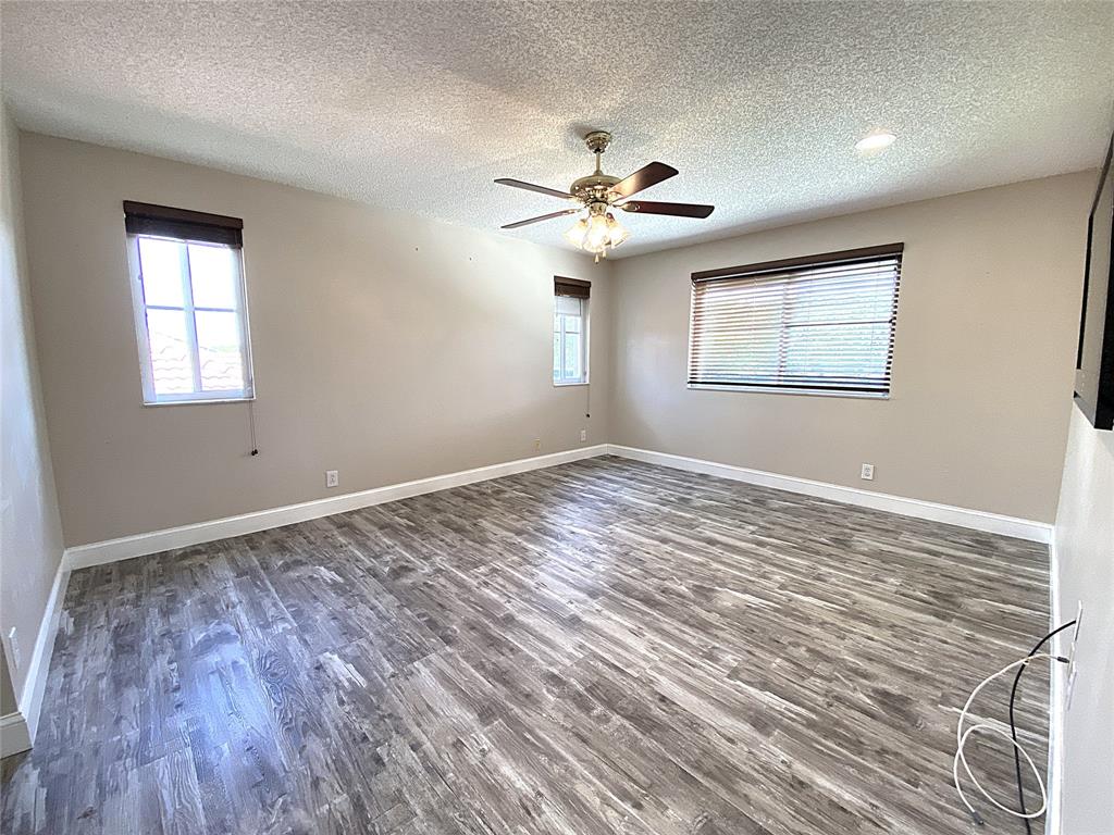 4375 Foxtail Lane Weston, FL 33331 - Photo 35 of 84 a view of an empty room with a window and wooden floor