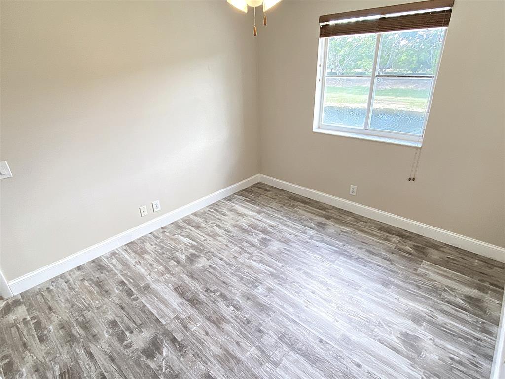 4375 Foxtail Lane Weston, FL 33331 - Photo 44 of 84 an empty room with wooden floor and windows