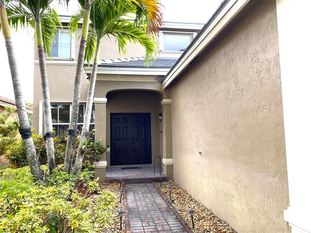 4375 Foxtail Lane Weston, FL 33331 - Photo 52 of 84 a front view of a house with garden
