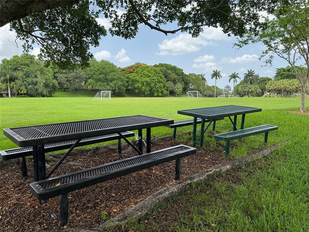 4375 Foxtail Lane Weston, FL 33331 - Photo 67 of 84 a view of a bench in the garden near a lake