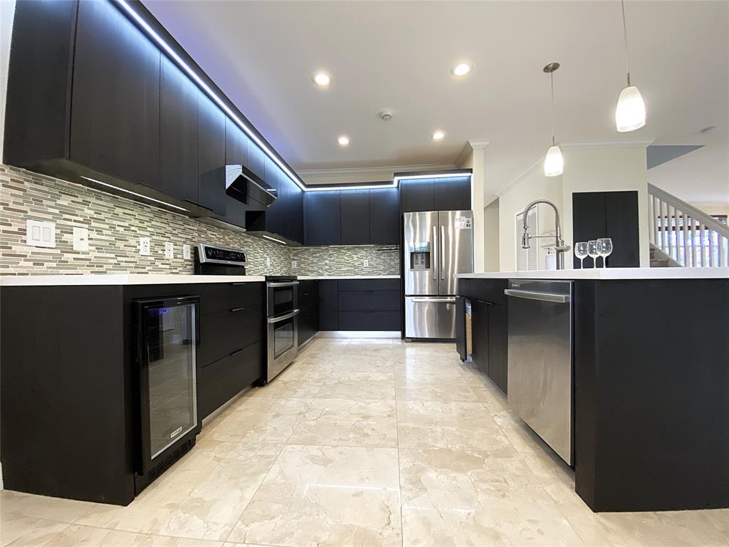 4375 Foxtail Lane Weston, FL 33331 - Photo 7 of 84 a large kitchen with kitchen island a sink stainless steel appliances and a counter top