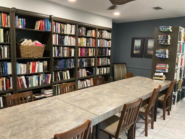 5680 Southwest 3rd Place, Unit 206 Margate, FL 33068 - Photo 19 of 22 a view of a dining room with furniture and a book shelf
