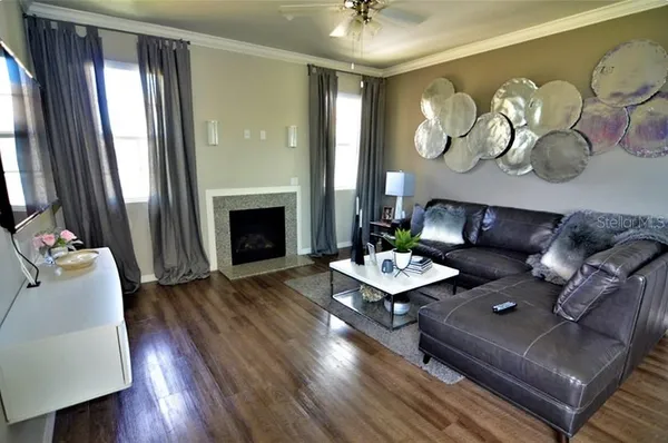 a living room with furniture and a fireplace