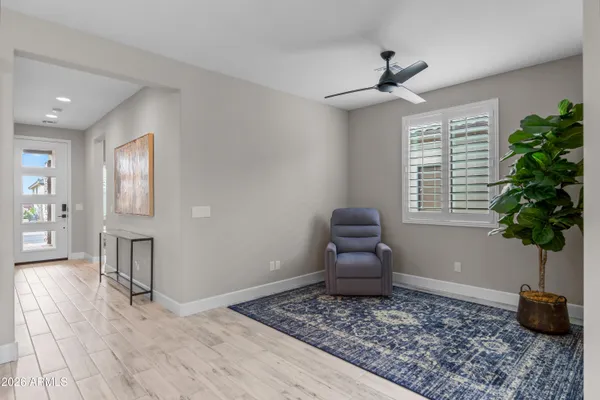 a living room with furniture and a potted plant