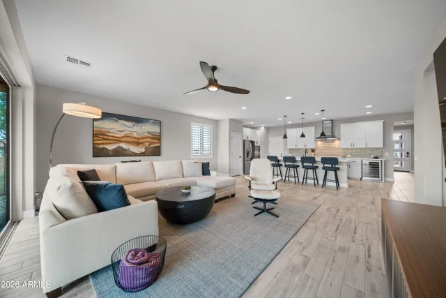 a living room with furniture and wooden floor