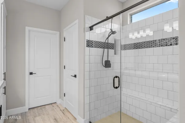 a bathroom with a glass shower door