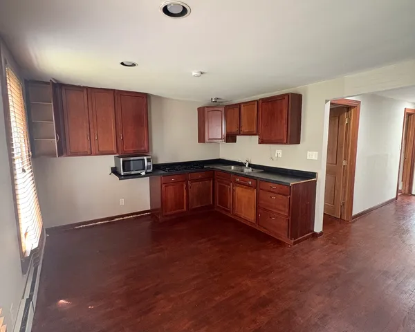 a kitchen with stainless steel appliances granite countertop a sink and cabinets