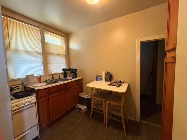 a kitchen with a sink and chairs