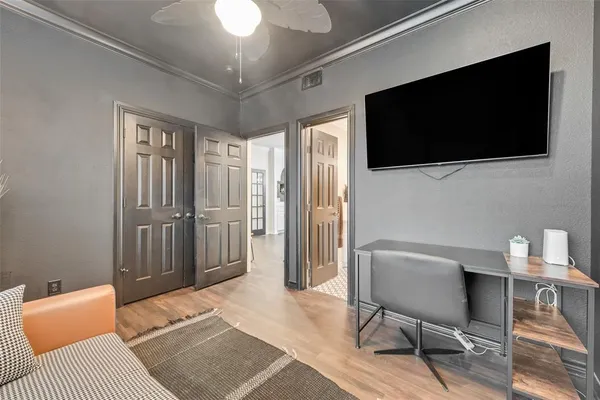 a bedroom with a bed tv and chair