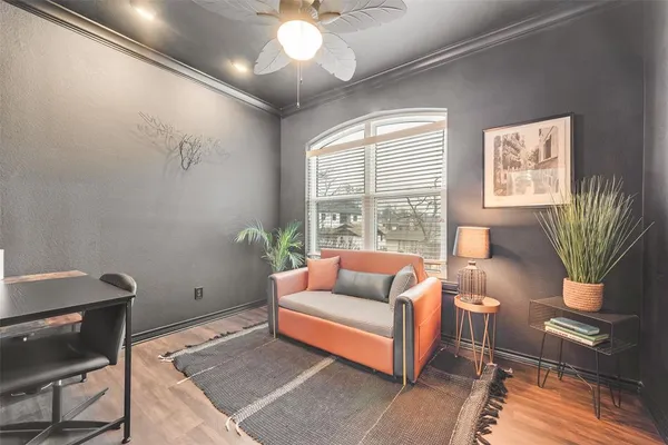 a living room with furniture and a potted plant