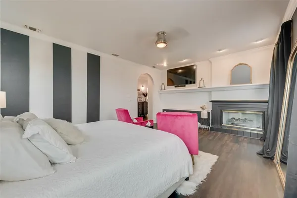 a bedroom with a bed and a television