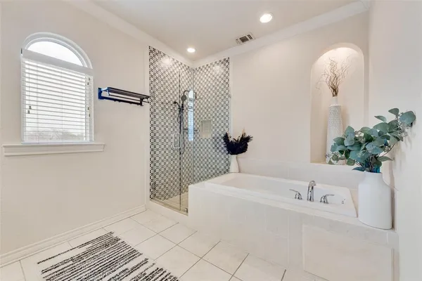 a bathroom with a bathtub and a shower
