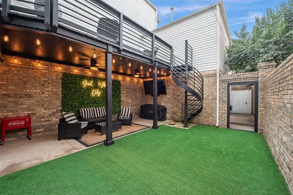 a view of a chair and table in backyard of the house