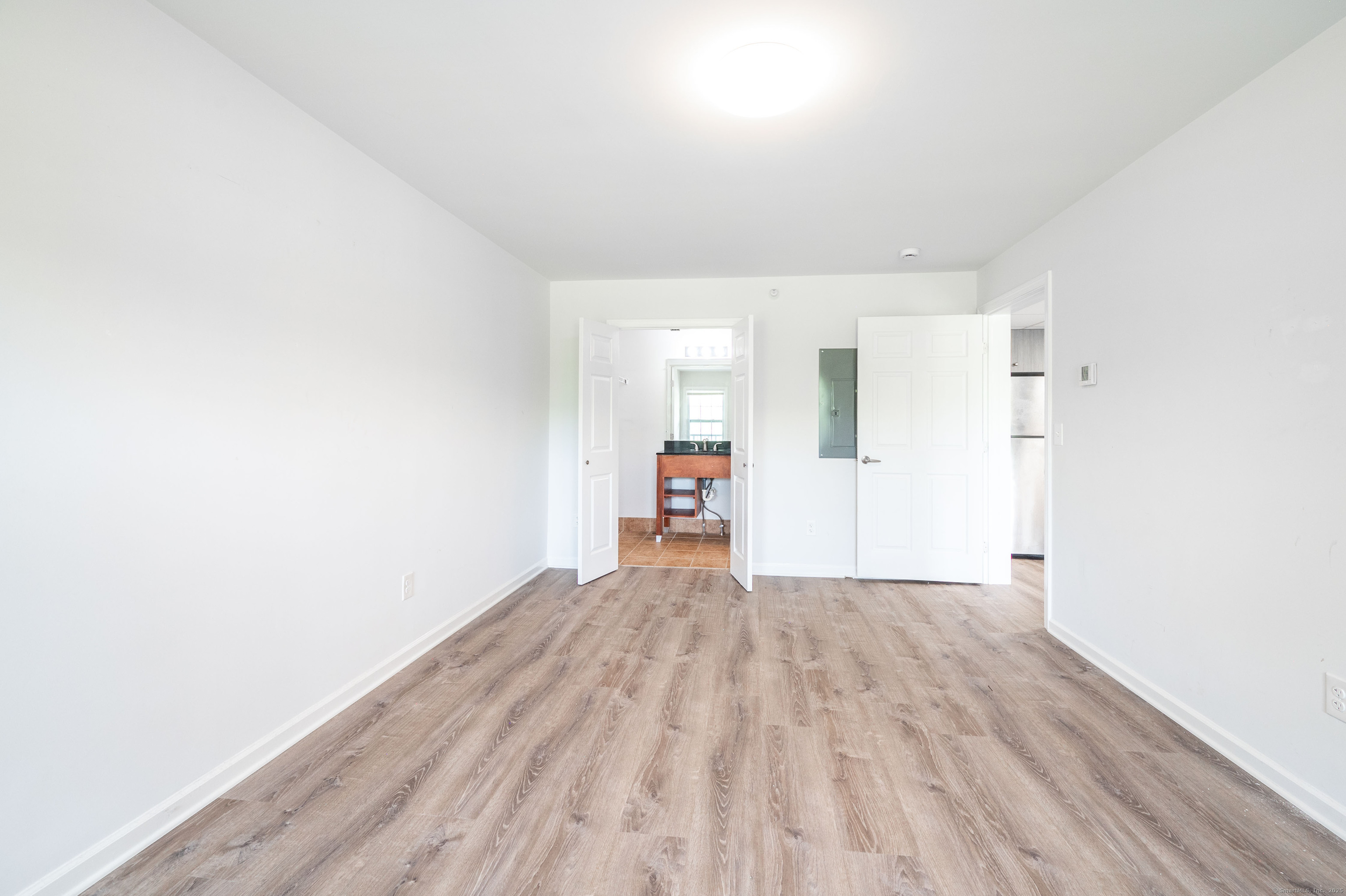 1030 Federal Road, Unit 201 Brookfield, CT 06804 - Photo 19 of 20 a view of a big room with wooden floor and windows