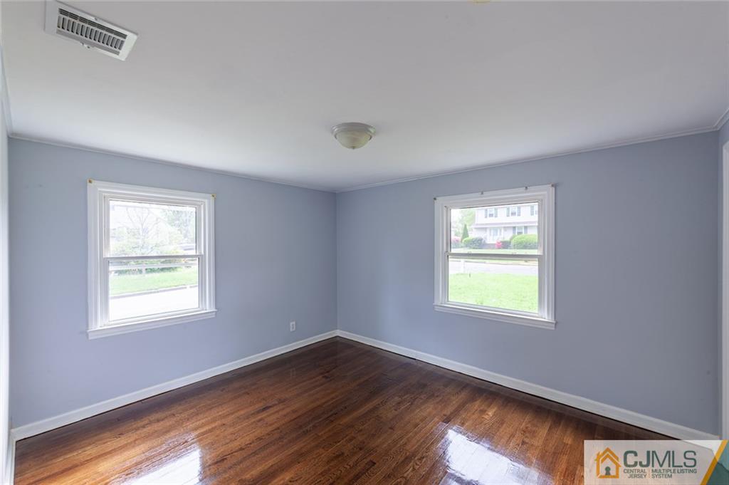 35 West Hill Road Colonia, NJ 07067 - Photo 14 of 19 a view of an empty room with wooden floor and a window