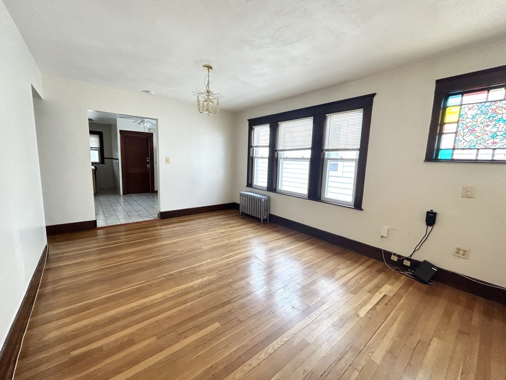 11 Romsey Street, Unit 3 Boston, MA 02125 - Photo 3 of 7 wooden floor in an empty room with a window