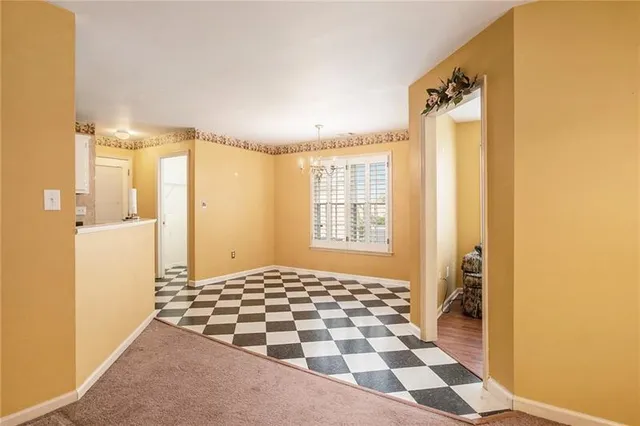 a bathroom with a black and white checkered floor