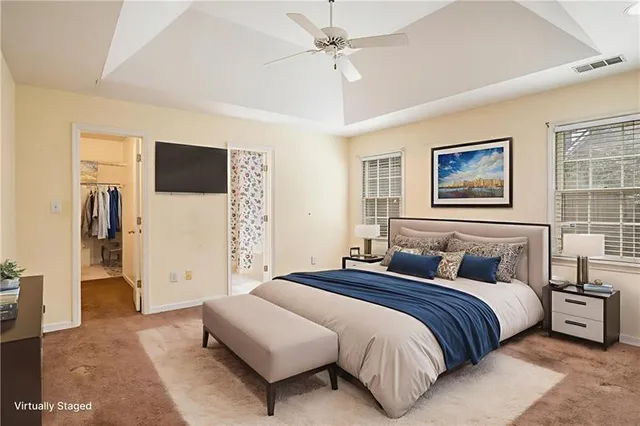 a bedroom with bed and a flat screen tv