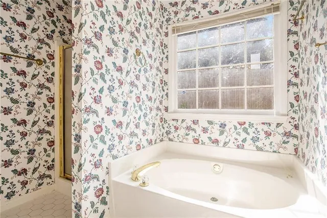 a bathroom with a bathtub and shower