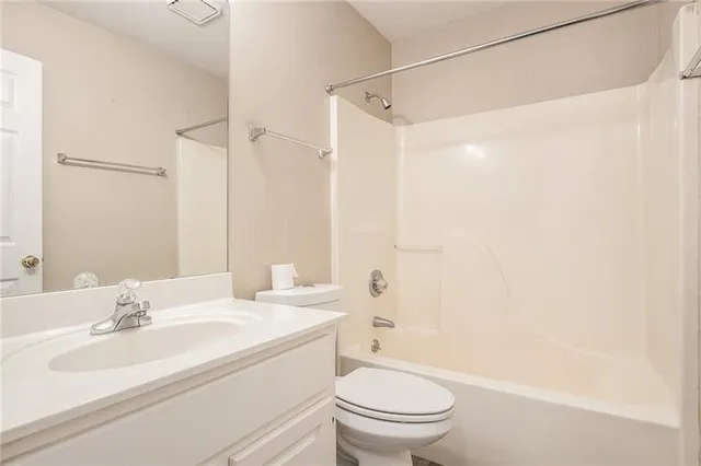 a bathroom with a sink toilet vanity and shower
