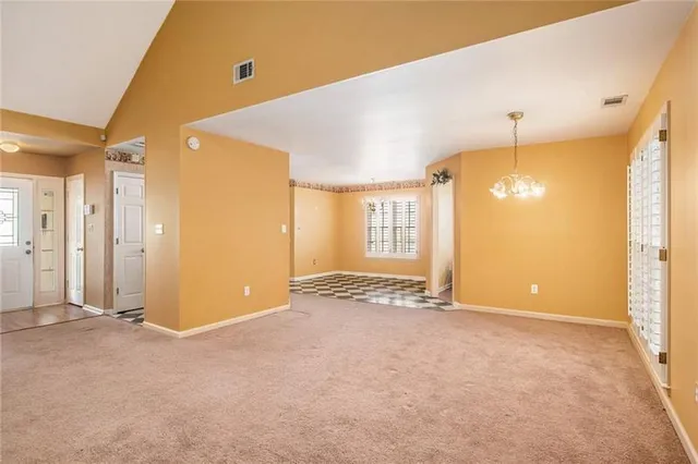 an empty room with windows and entrance