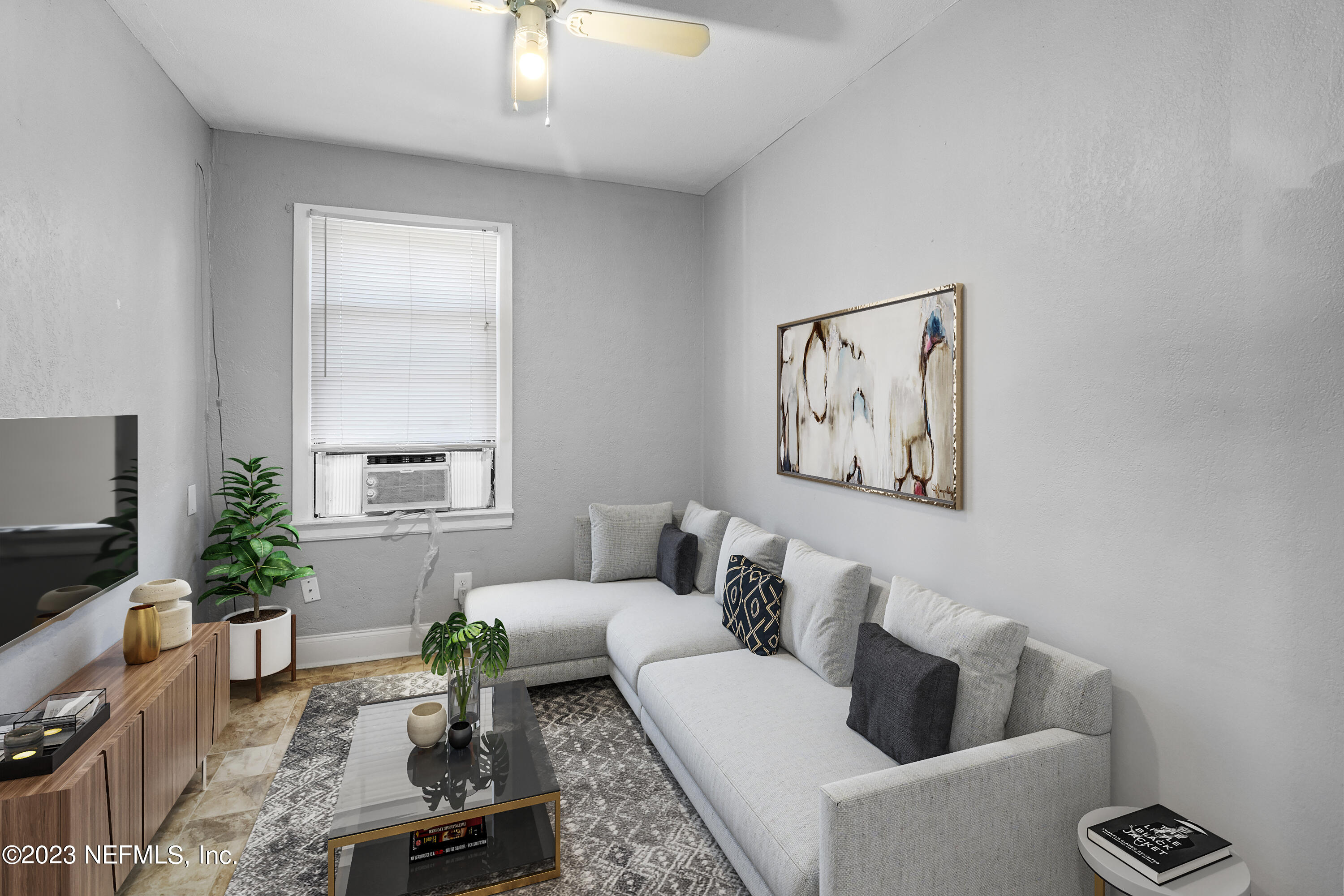 a living room with furniture and a potted plant