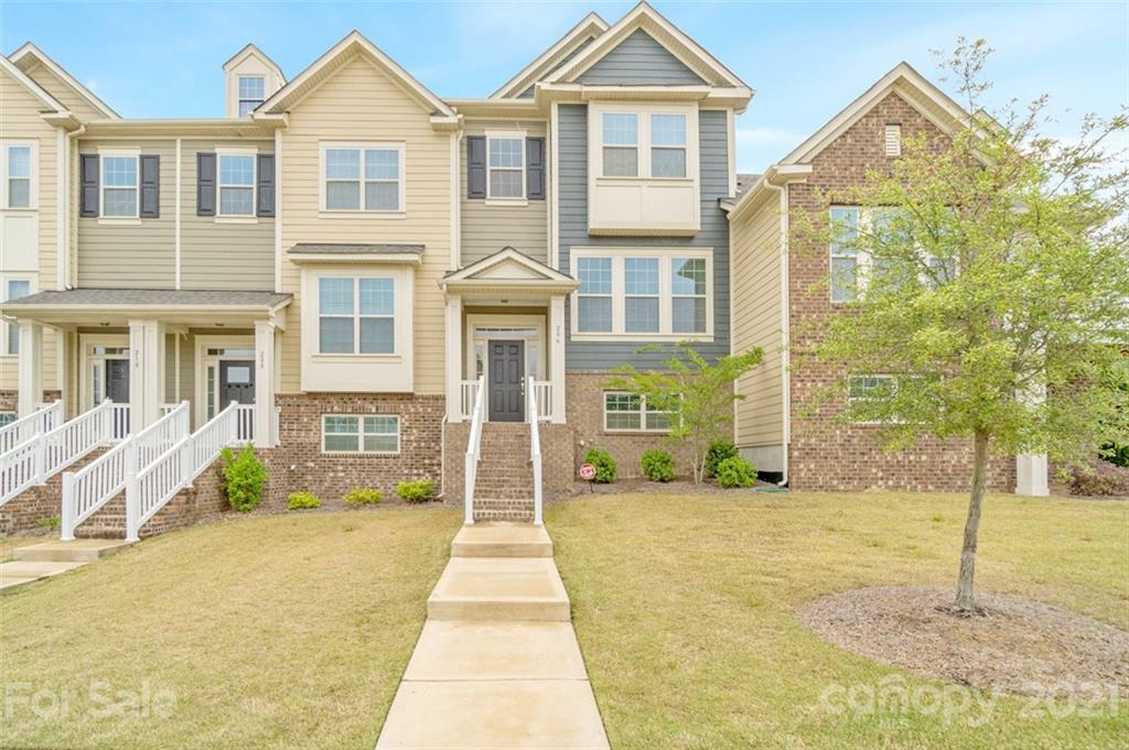 206 Butterfly Place, Unit 185 Tega Cay, SC 29708 - Photo 1 of 36 a front view of a house with a yard