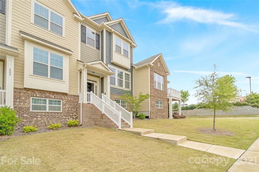 206 Butterfly Place, Unit 185 Tega Cay, SC 29708 - Photo 2 of 36 a view of a brick house with a street