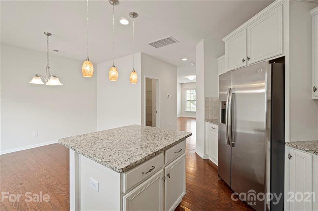 206 Butterfly Place, Unit 185 Tega Cay, SC 29708 - Photo 16 of 36 a kitchen with a refrigerator and countertop