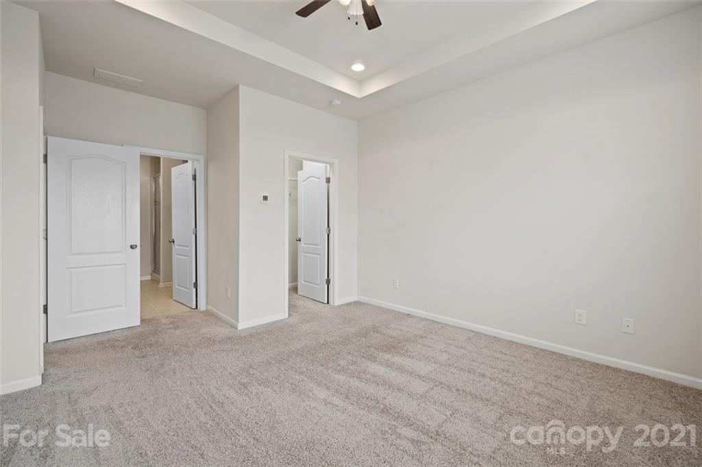 206 Butterfly Place, Unit 185 Tega Cay, SC 29708 - Photo 23 of 36 a view of an empty room and chandelier fan