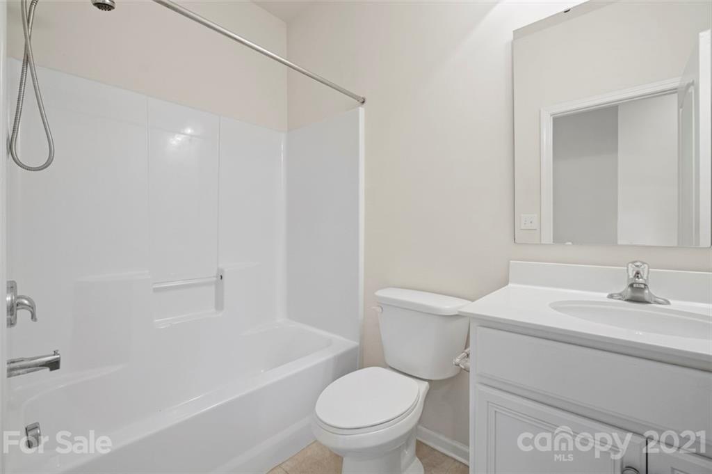 206 Butterfly Place, Unit 185 Tega Cay, SC 29708 - Photo 28 of 36 a bathroom with a sink toilet vanity and shower