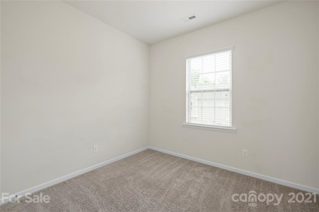 206 Butterfly Place, Unit 185 Tega Cay, SC 29708 - Photo 29 of 36 an empty room with a window