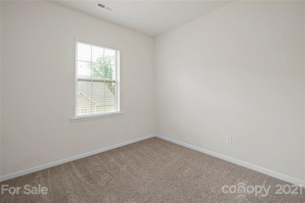 206 Butterfly Place, Unit 185 Tega Cay, SC 29708 - Photo 31 of 36 an empty room with a window