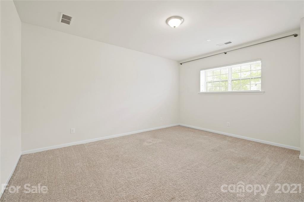 206 Butterfly Place, Unit 185 Tega Cay, SC 29708 - Photo 34 of 36 an empty room with a window