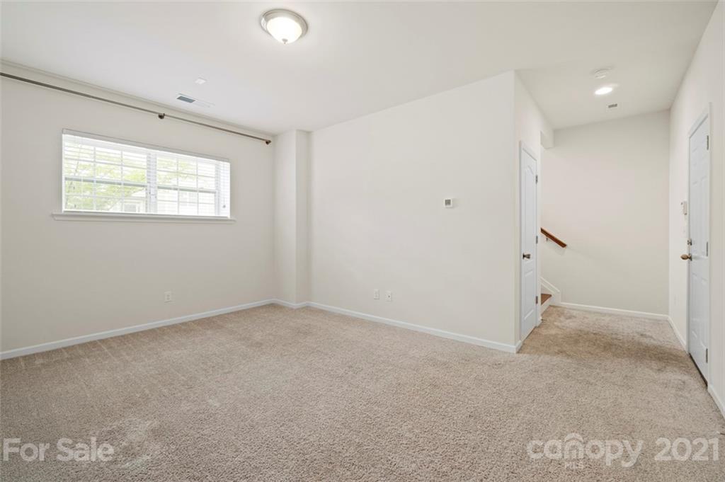 206 Butterfly Place, Unit 185 Tega Cay, SC 29708 - Photo 35 of 36 an empty room with an entryway and window