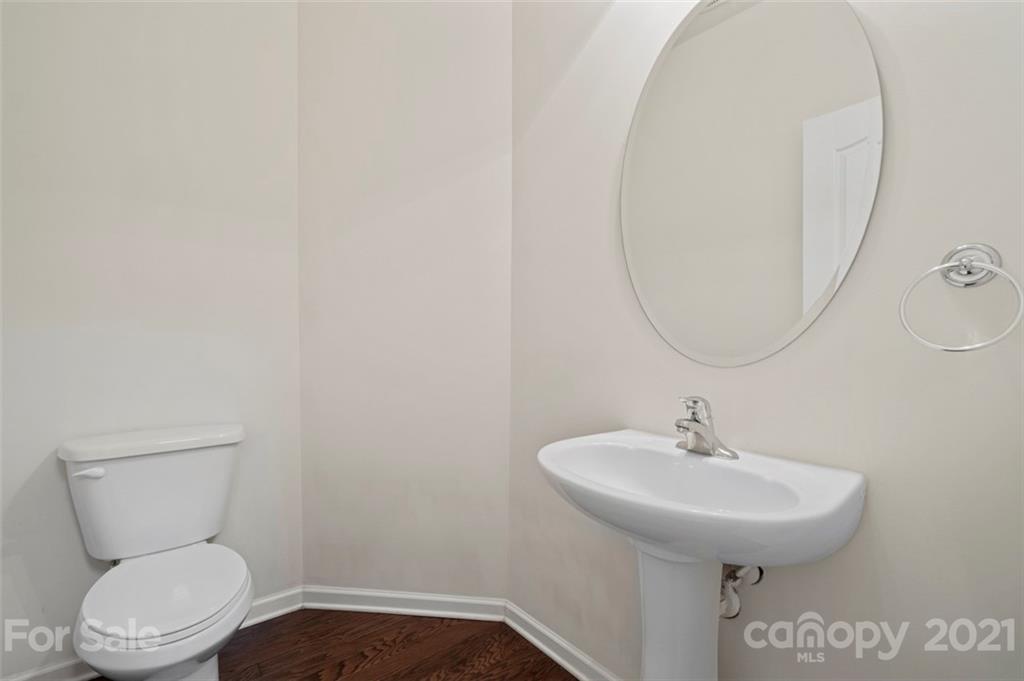 206 Butterfly Place, Unit 185 Tega Cay, SC 29708 - Photo 5 of 36 a bathroom with a toilet sink and mirror