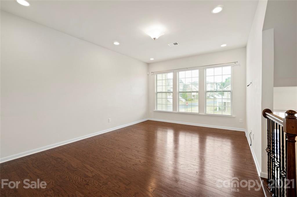 206 Butterfly Place, Unit 185 Tega Cay, SC 29708 - Photo 7 of 36 wooden floor in an empty room with a window