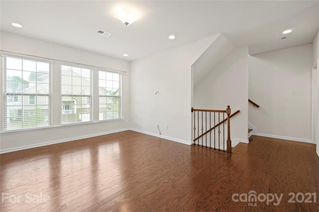 206 Butterfly Place, Unit 185 Tega Cay, SC 29708 - Photo 8 of 36 wooden floor in an empty room with a window
