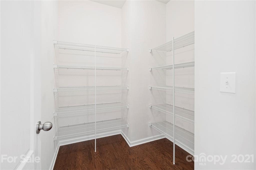 206 Butterfly Place, Unit 185 Tega Cay, SC 29708 - Photo 10 of 36 a view of walk in closet with empty racks