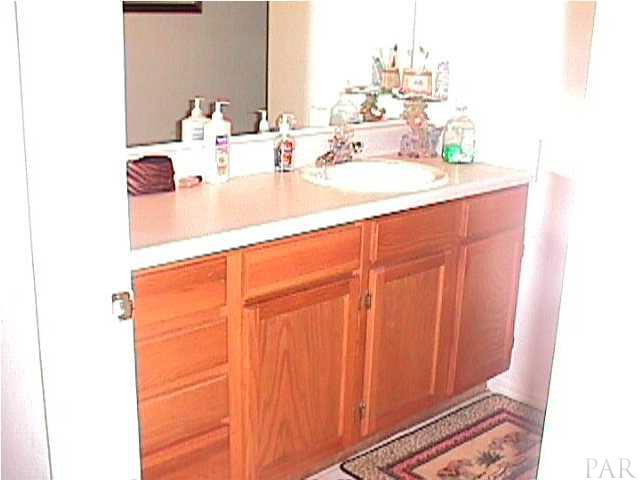 5334 Sewell Road Milton, FL 32570 - Photo 2 of 7 a bathroom with a sink and a mirror