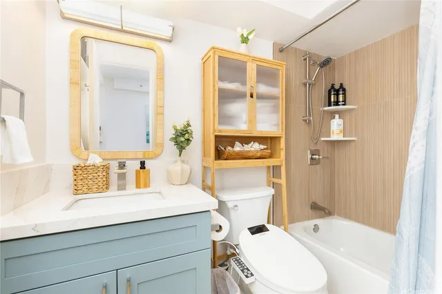 a bathroom with a sink a toilet and shower