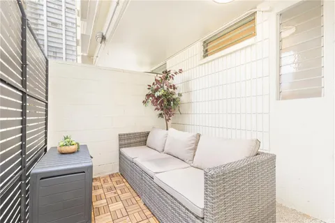 a living room with furniture and flowers