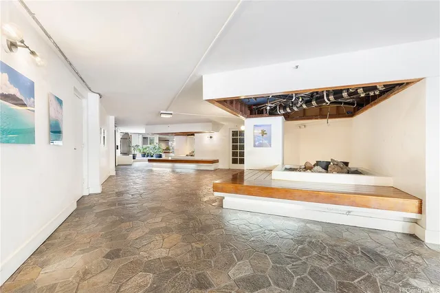 a view of a living room with kitchen countertops and a couch