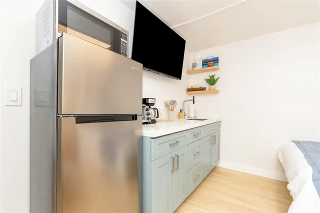 a kitchen with a refrigerator and a sink