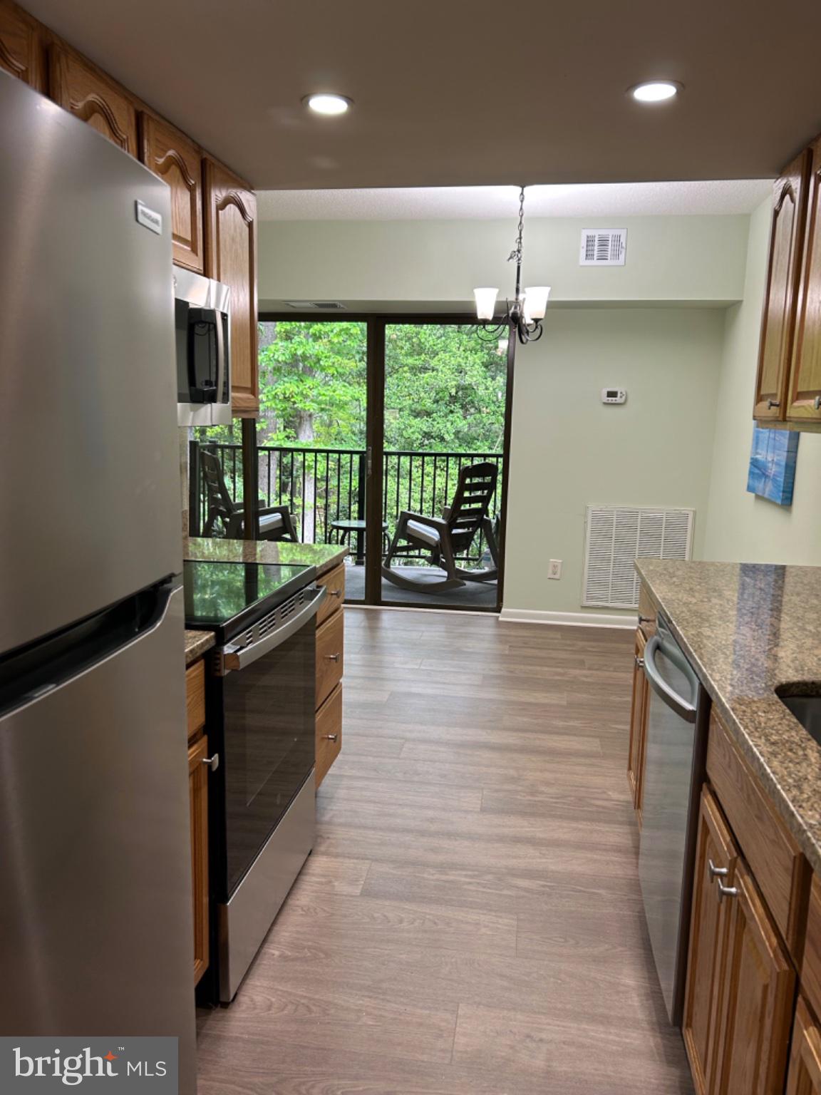 11609 Stoneview Square, Unit 11C Reston, VA 20191 - Photo 27 of 30 Bright kitchen with serene balcony view.