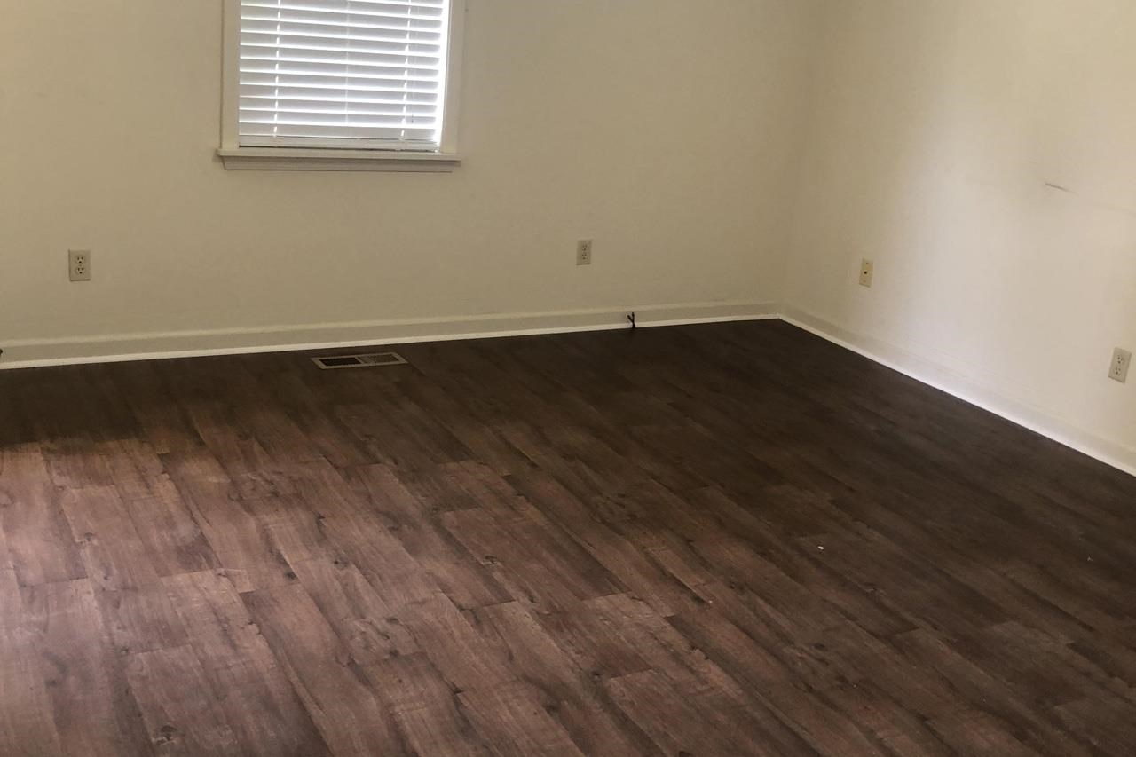 Barlow-chisholm Lake Road Ripley, TN 38063 - Photo 10 of 13 an empty room with wooden floor and windows