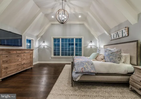 a spacious bedroom with a bed and ceiling fan