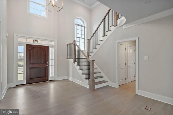 a view of entryway with stairs and wooden floor
